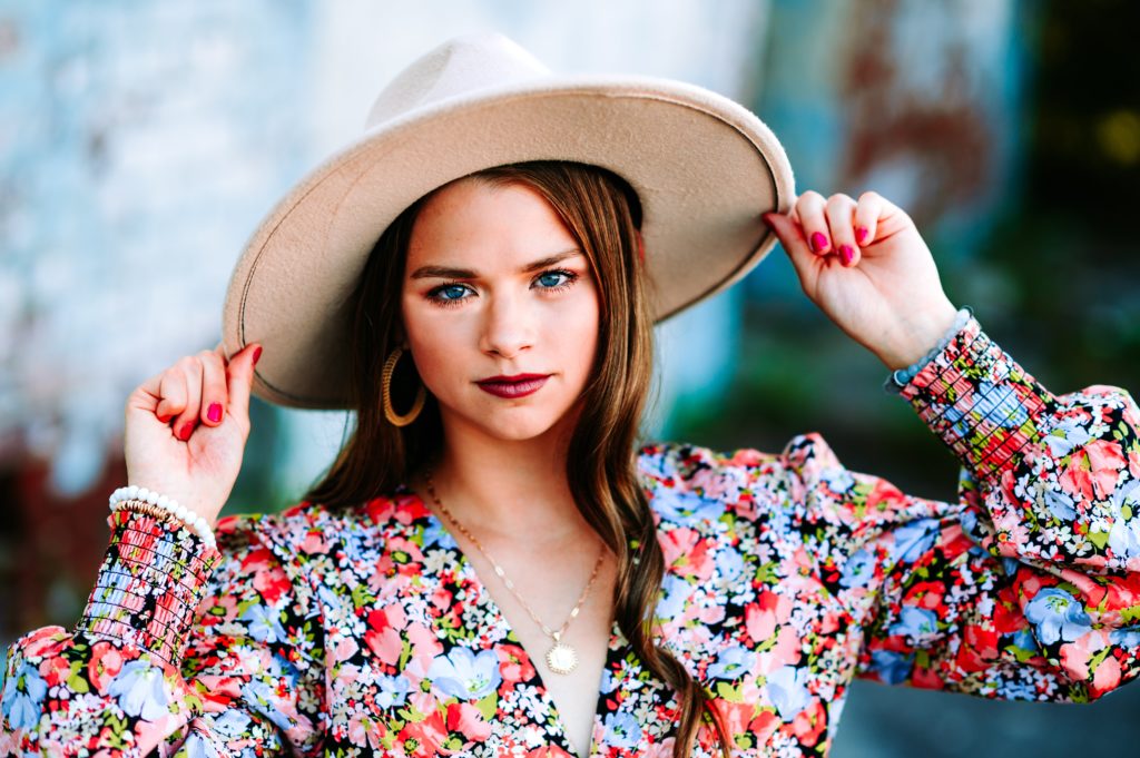 girl with floral dress and sun hat. Best Location for Senior Photos