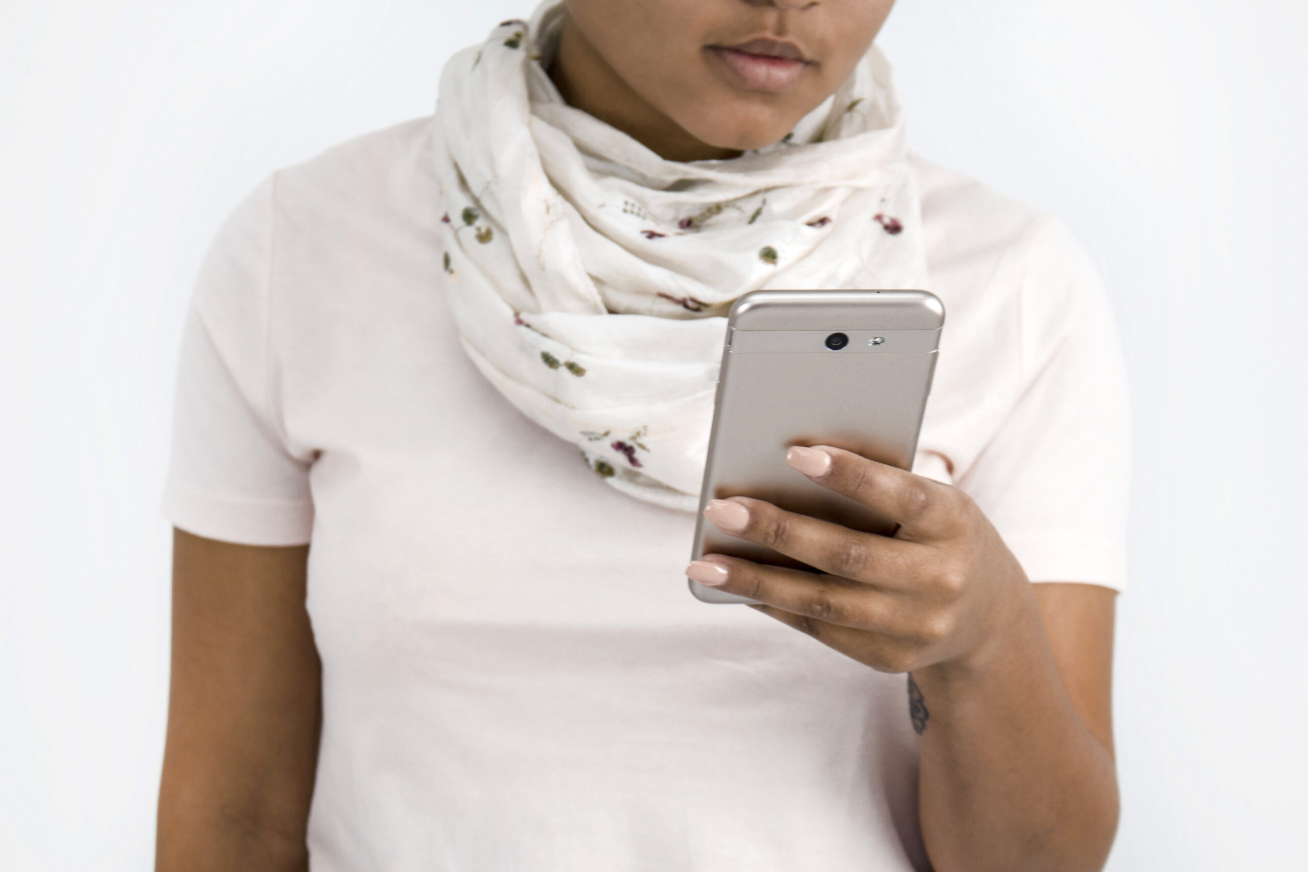 African American girl wearing a scarf looking on her cell phone. Senior Session Timeline