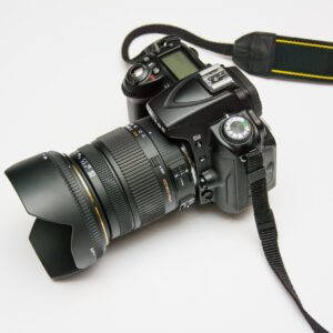 black dslr camera on white surface