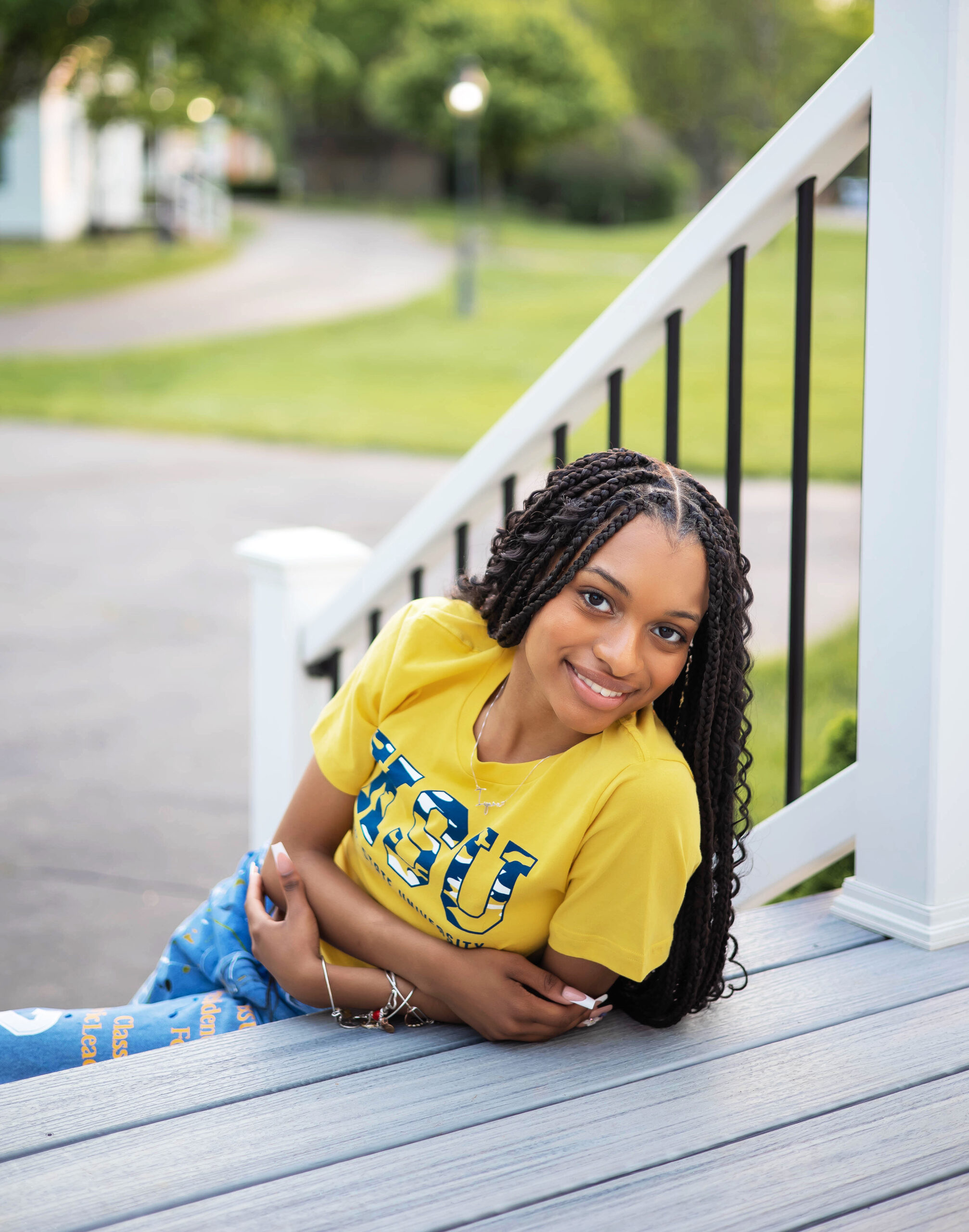 African American girl sitting on steps wearing a Kent State University t-shirt at Taylor Heritage Park