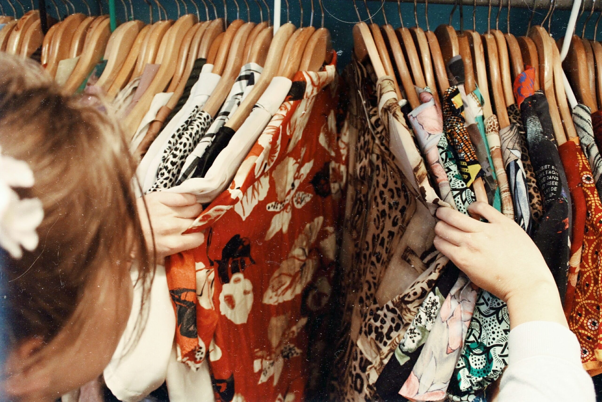 girl looking through clothes. Things NOT to Wear to Your Senior Photoshoot