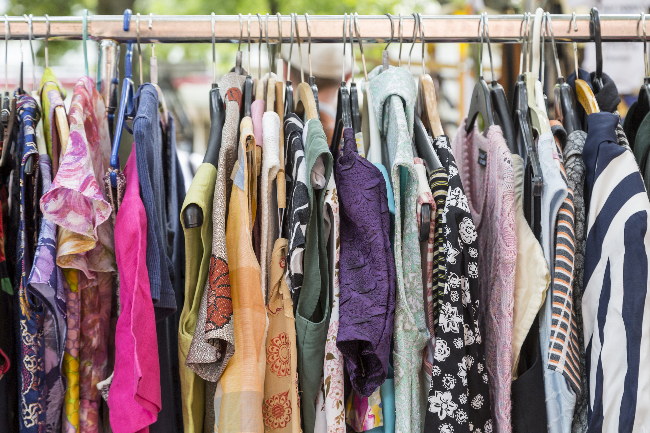 clothes on a rack on a flea market. Things NOT to Wear to Your Senior Photoshoot